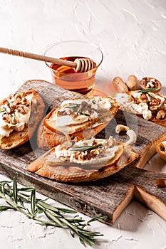 Bruschetta with pear, cheese camembert nuts and honey. Food recipe background. Close up