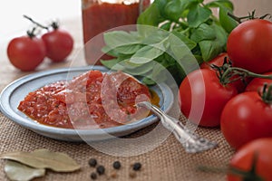 Bruschetta Sauce, Fresh Red Tomatoes and Green Basil Leaves, and Some Spices, Rustic Background, Close Up on a Kitchen Table