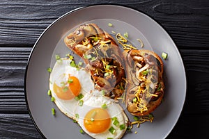 Bruschetta with shiitake mushrooms and cheddar cheese served with fried eggs close-up. Breakfast is healthy. horizontal top view