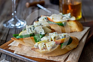 Bruschetta with spinach, pear and blue cheese. Wine. Vegetarian food. Healthy eating. Veganism. Diet