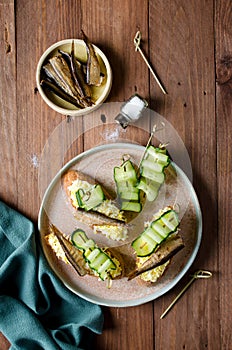 Bruschetta with sprats, egg and cucumber