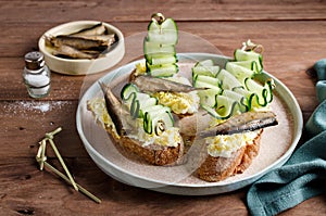 Bruschetta with sprats, egg and cucumber