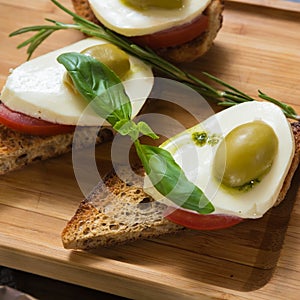 Bruschetta with tomato, mozarella and olive