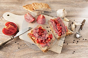 Bruschetta with tomatoes on rustic, old wood background