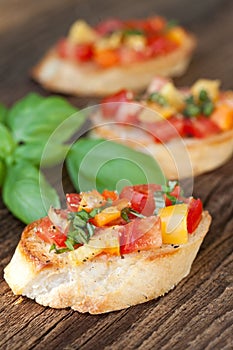 Bruschetta topped with tomato, paprika, garlic photo