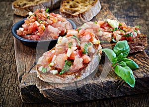 Bruschettas ingredients on wooden cutting board