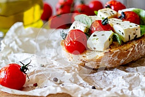 Bruschettas with tomatoes and cheese. Italian cuisine. Rustic style. Vegetarian food