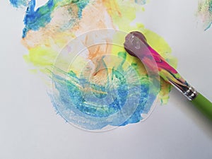 Brush with bright paints on a white background hobbies