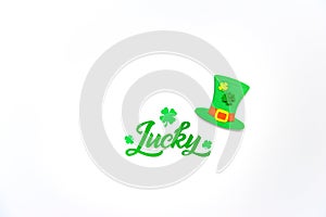 Brush calligraphy design with clover shamrock leaf and Leprechaunâ€™s hat.