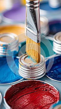 Brush close up on vibrant paint cans, artistic tools and colors