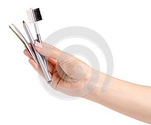 Brush for eyebrow pencil tweezers in hands