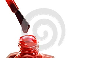 Brush and jar with red nail polish, isolated
