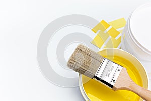 Brush over can of yellow paint