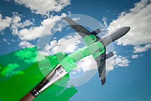 brush painting green an aircraft. Greenwashing malpractice, Zero emissions, SAF or Sustainable Aviation Fuel and biofuel