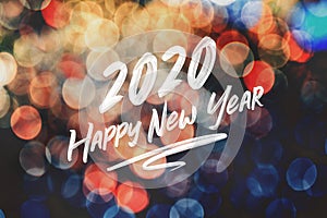 Brush stroke handwriting 2020 happy new year on abstract festive colorful bokeh light background,holiday greeting card