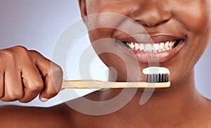 Brush them religiously. Studio shot of a beautiful young woman brushing her teeth.