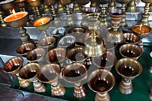 Brushed metal pot. Preparing for candle in a monastery in Bhutan.