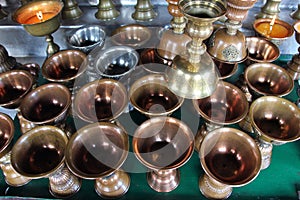 Brushed metal pot. Preparing for candle in a monastery in Bhutan.