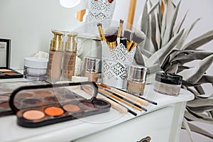 A Brushes, colours, shades and tools for a make up artist are on a table