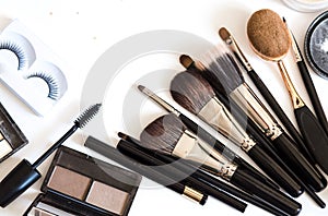 Brushes for decorative cosmetics for make up on white background top view flatlay.