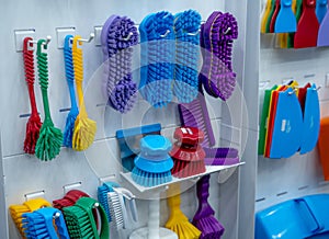 Brushes hang on shelf. Dish wash brush, professional double wing scrub, round scrub for food processing and manufacturing.