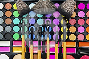 Brushes over colorful makeup palette