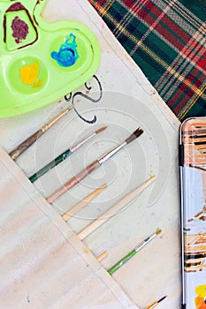 Brushes set with palette on the table