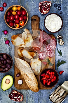 Brushetta or authentic traditional spanish tapas set for lunch table. Sharing antipasti on party picnic time on blue background