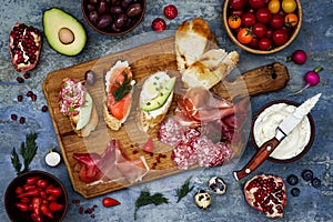 Brushetta or authentic traditional spanish tapas set for lunch table. Sharing antipasti on party picnic time on blue background