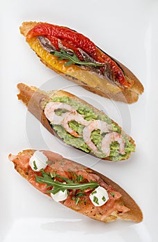Brushetta snacks for wine. Variety of small sandwiches on a textile background