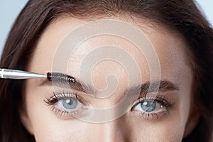 Brushing Eyebrows. Woman Shaping Brows With Brush. Beautiful Girl Close Up Portrait.