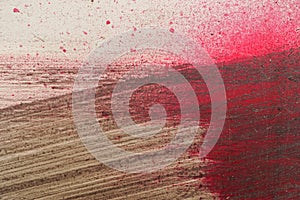 Brushstroke with brown and red paint on dusty metal fence