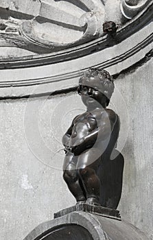 Brussels, B, Belgium - August 18, 2022: Manneken Pis is famous a fountain with a statue of boy