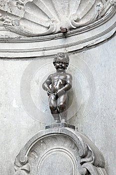 Brussels, B, Belgium - August 18, 2022: Manneken Pis is famous a fountain with a statue of boy