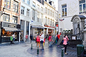 Group of tourists visiting Manneken Pis or Little Man Pee located near Grand Place in the city of Brussels, Belgium