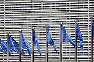 Blue flags of Europe in front of Berlaymont, seat of the European Commission, Brussels, Belgium photo