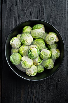 Brussels sprouts, on black wooden table, flat lay