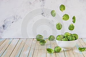 Brussels sprouts flying over a bowl. Fresh Brussels sprouts. Levitation concept