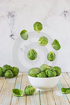 Brussels sprouts flying over a bowl. Fresh Brussels sprouts. Levitation concept