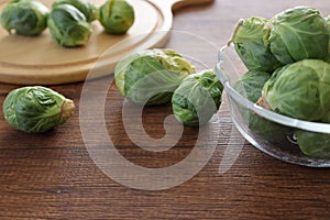 Brussels sprouts in a glass bowl on a wooden table