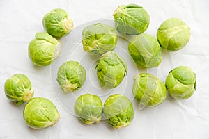 Brussels sprouts green vegetables on light table background. Flat lay close up top view copyspace design. Health food lifestyle