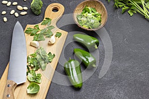 Brussels sprouts, parsley leaves and knife on cutting board