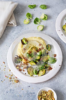 Brussels sprouts with pistachios, raisins and Skordalia mashed potatoes. Healthy Meal preparation. Plant-based dishes. Green