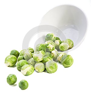 Brussels sprouts and plate on white background