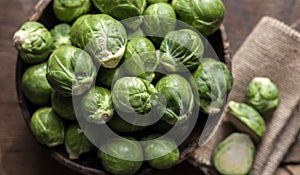 Brussels Sprouts in wooden bowl on rustic background