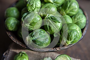 Brussels Sprouts in wooden bowl on rustic background