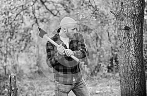 brutal and attractive male in forest. power and strength. lumberjack carry ax. bald woodsman worker. live on rancho