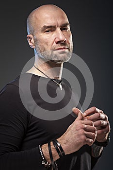 Brutal bald man, dark background