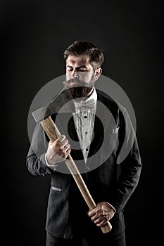 Brutal and bearded. Brutal groom hold axe. Hipster keep sharp axe blade at unshaven face. Bearded man with brutal look