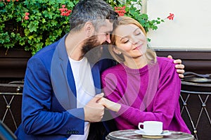 Brutal bearded hipster man and woman drink coffee. woman and man with beard relax in cafe. Couple in love on romantic